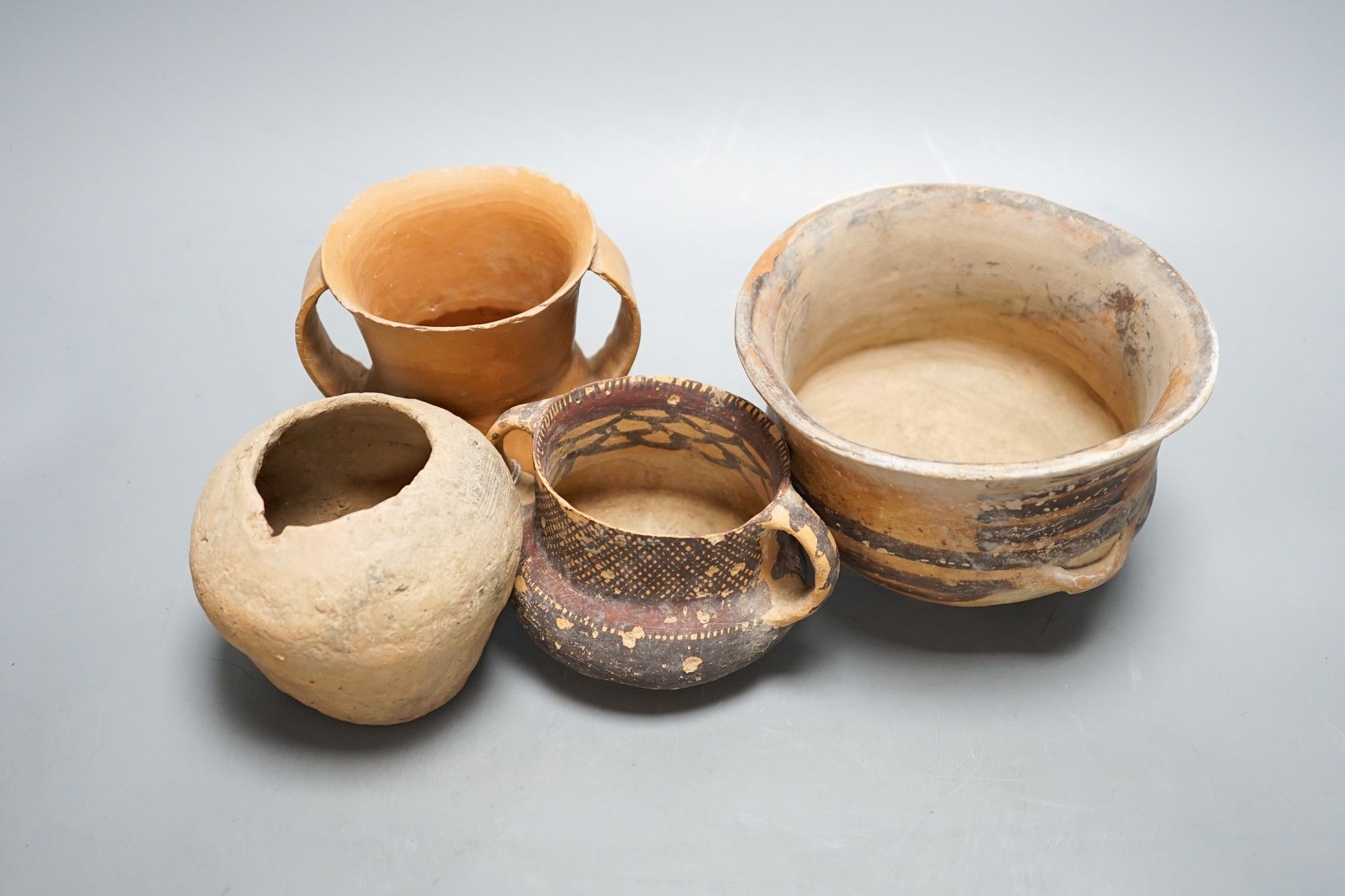 Four Chinese Neolithic pottery vessels, 11cm